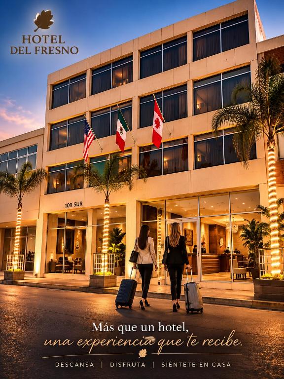 two people walking in front of a hotel with their luggage at Hotel del Fresno in Fresnillo de González Echeverría