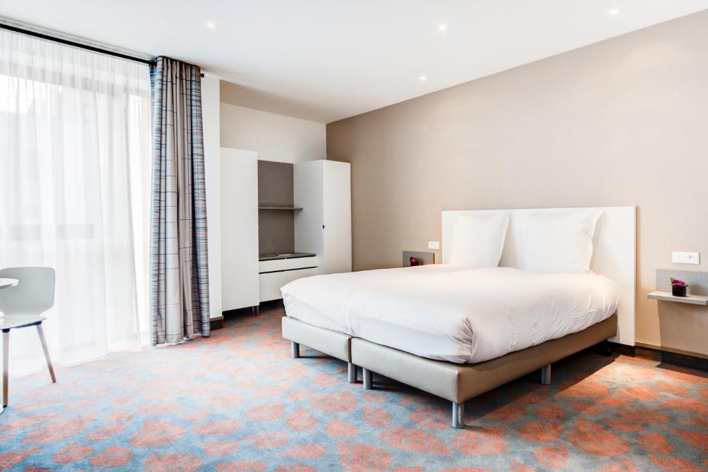 Postel nebo postele na pokoji v ubytování Hotel ParkSaône