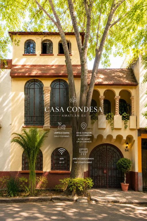 a house with a tree in front of it at Casa Condesa Amatlan 84 Hotel by Riberana in Mexico City