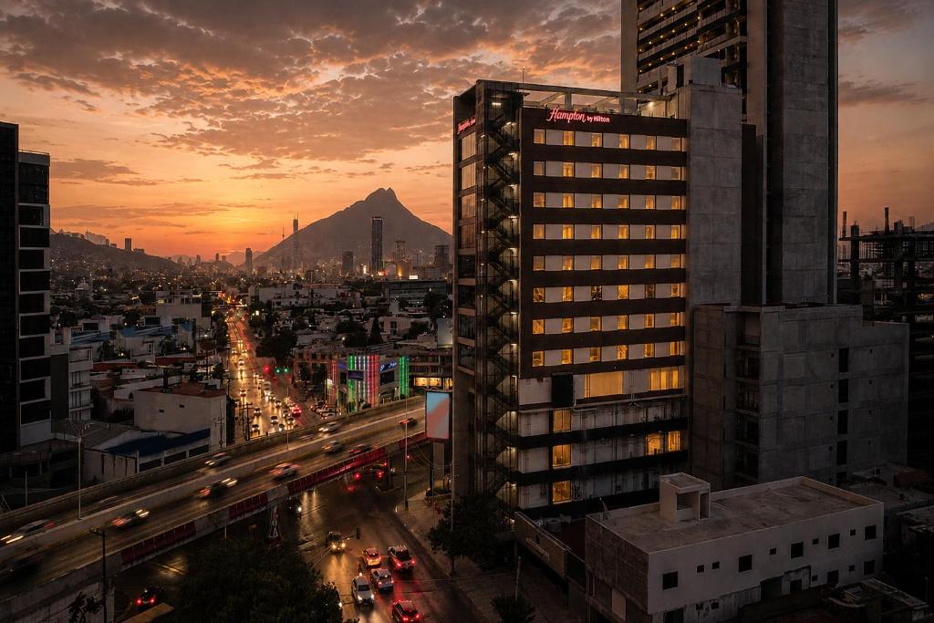 a view of a city with a mountain in the background at Hampton by Hilton Monterrey Tecnológico in Monterrey