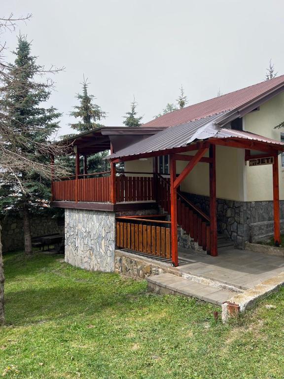 a house with a deck on the side of it at Villa JETI in Tetovo