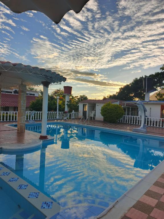 a pool at a resort with a cloudy sky at Alborada Chinauta in La Serena