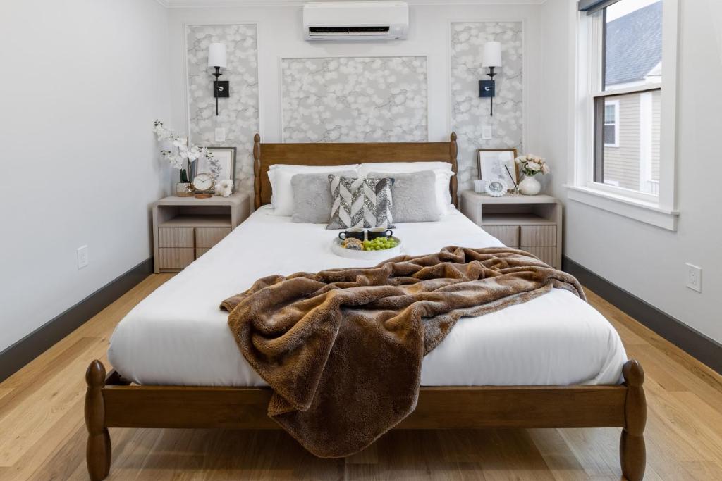 a bedroom with a large bed with a blanket on it at Cambridge Designer Home Harvard MIT Boston in Cambridge