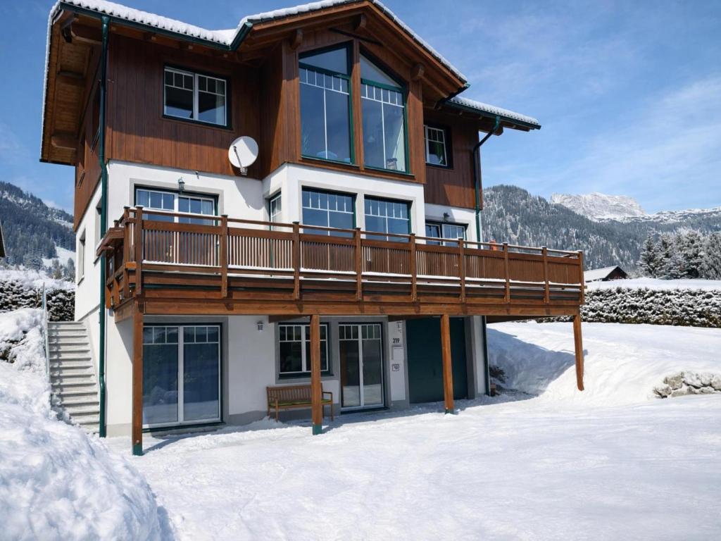 a house with a deck in the snow at Landhaus Alpenblick Tauplitz in Tauplitz