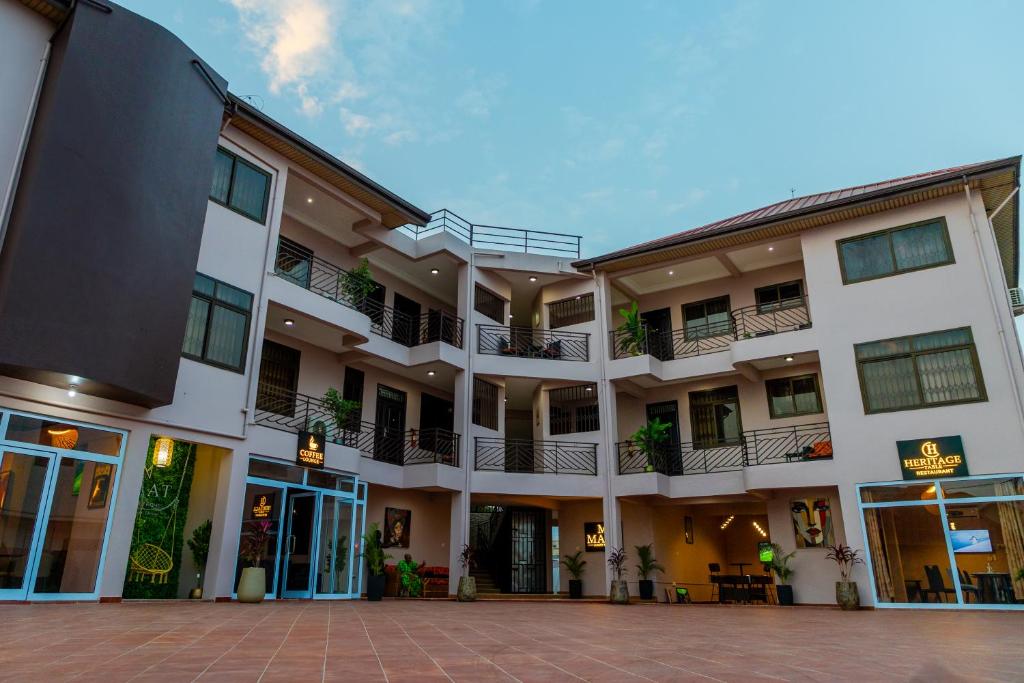 an apartment building with balconies and a courtyard at MAAT Luxury Homes in Accra