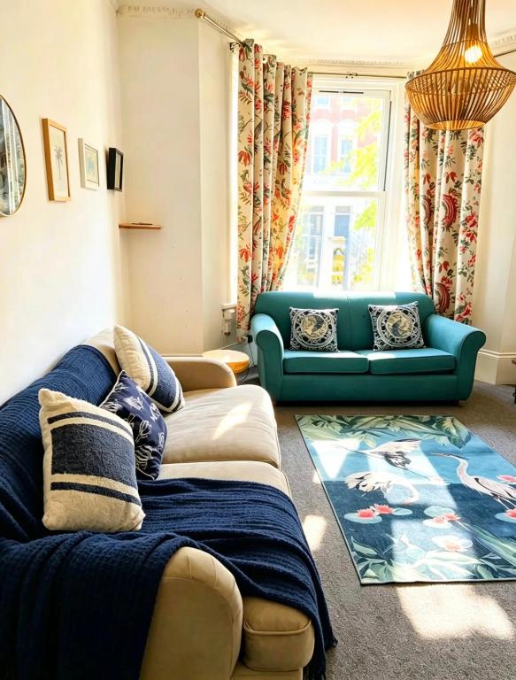 a living room with two couches and a blue couch at St Leonards in Hollington