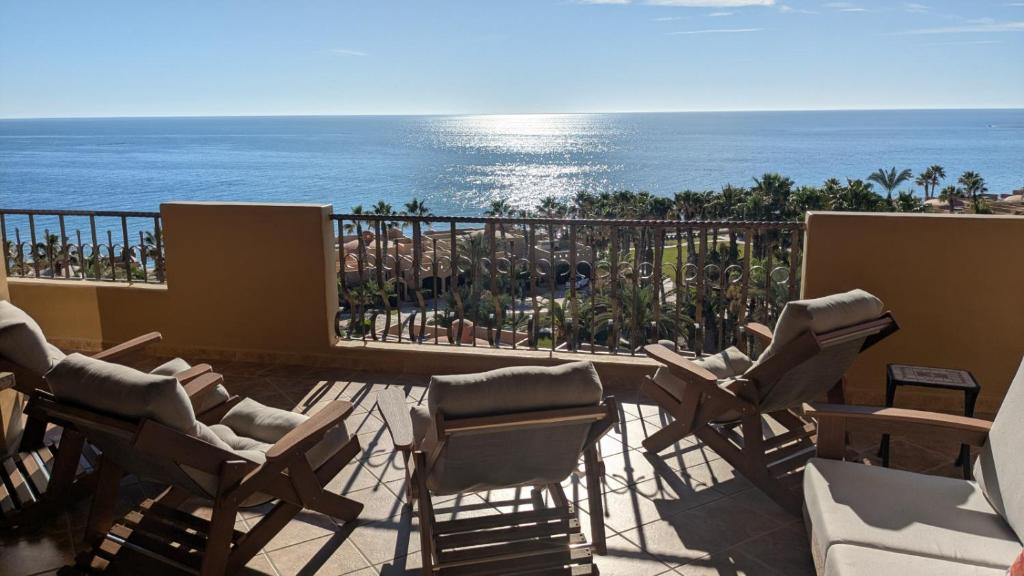 a balcony with chairs and a view of the ocean at Bella Sirena 502-A Beachfront Luxury - Best Views, Best Location in Puerto Peñasco