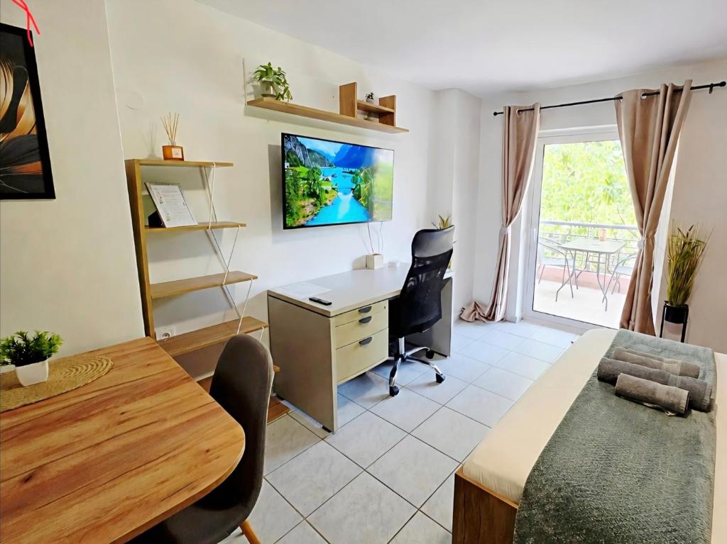 a living room with a desk and a table and a desk at The Garden Studio - Spacious Balcony in Lamía
