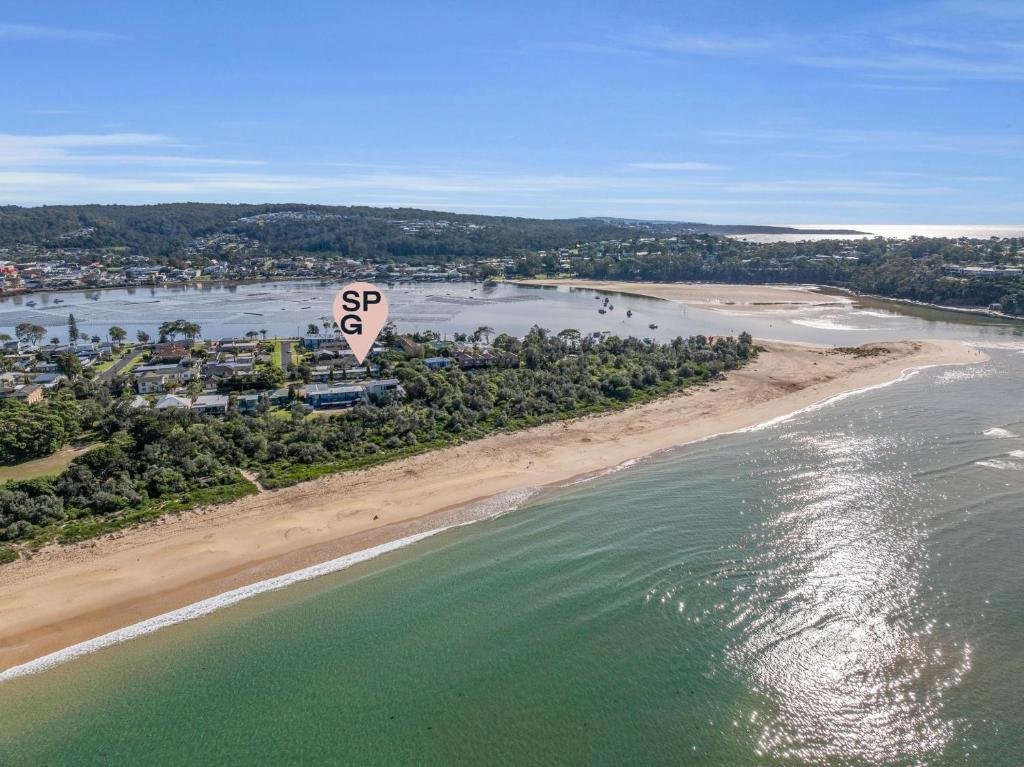 an aerial view of a beach and the ocean at Seasider in Merimbula