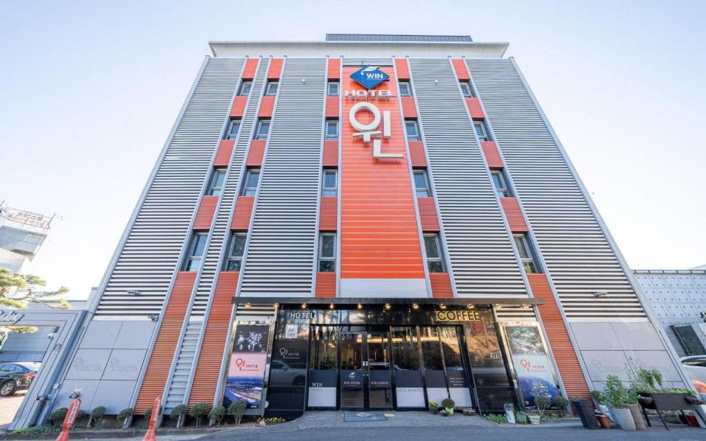 a tall building with an orange and gray at Andong Win Hotel in Hoam-dong