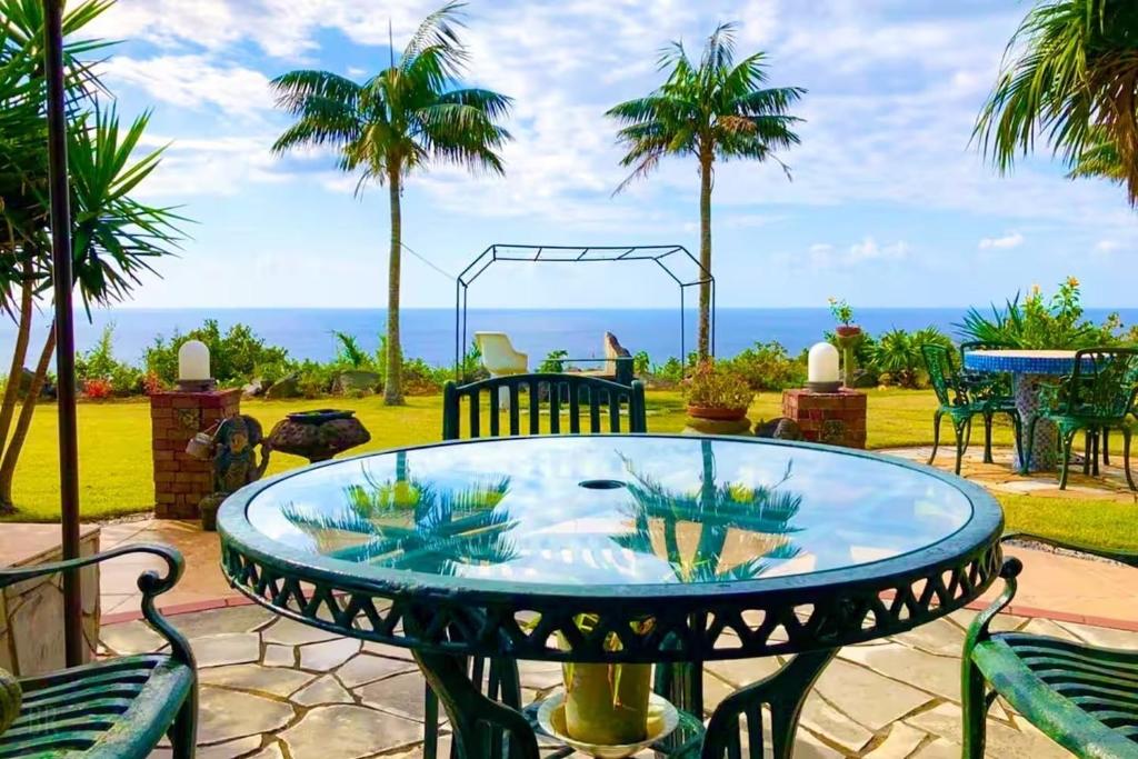 a patio with a table and chairs and the ocean at Green Post - Vacation STAY 21855v in Yaene