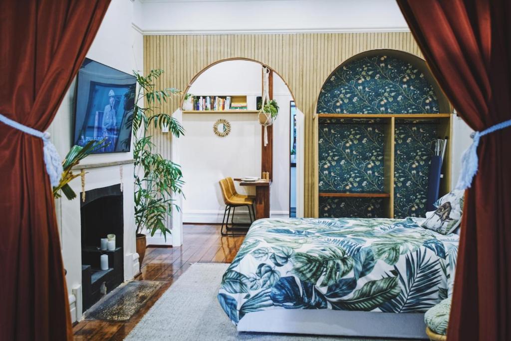 a bedroom with a bed and a fireplace at Private sanctuary between river and sea in Perth