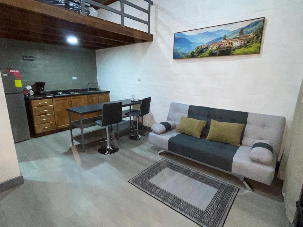 a living room with a couch and a table at Mini Loft en Quezaltepeque in Quezaltepeque