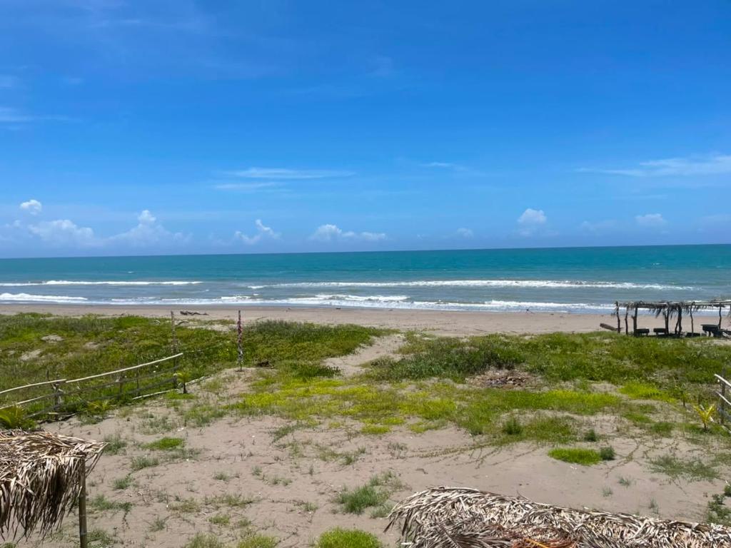 a view of a beach with a pier and the ocean at Departamento al lado del Mar in Barra Nueva