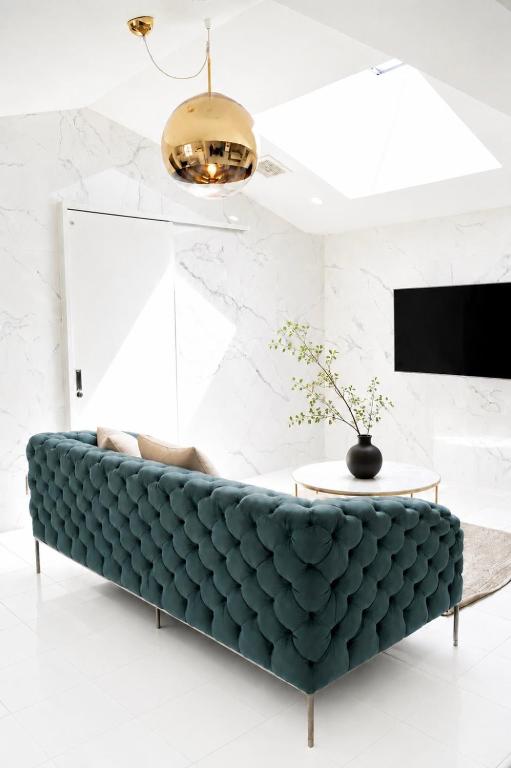 a green couch in a living room with a table at THE ROOT2 HOTEL in Kyoto