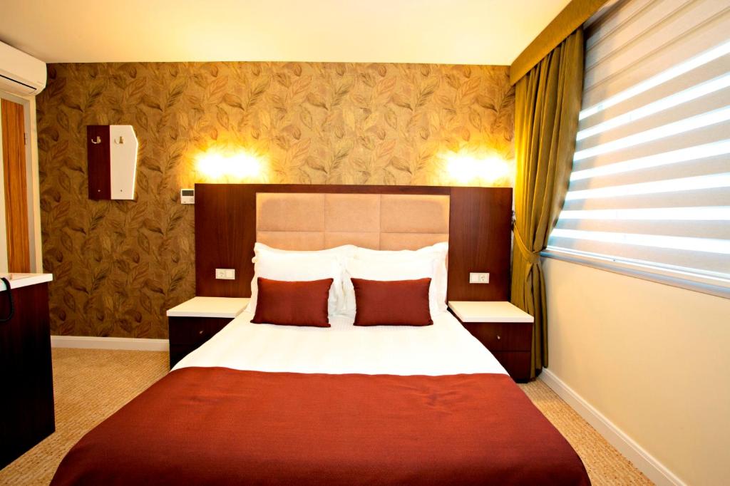 Postel nebo postele na pokoji v ubytování Endglory Hotel