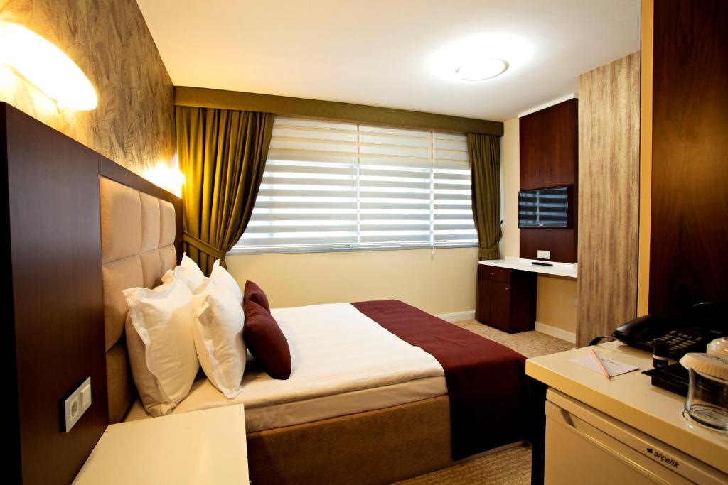 Postel nebo postele na pokoji v ubytování Endglory Hotel