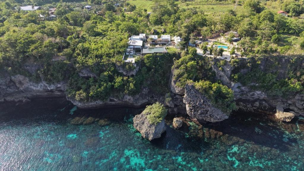 an aerial view of a house on a cliff over the ocean at Siquijor Jade ocean resort in Siquijor