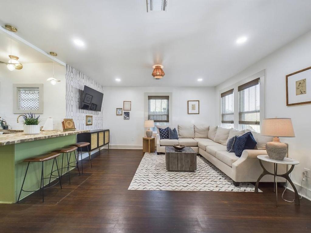 a living room with a couch and a kitchen at Buchanan Bungalow - Eclectic Mid-Mod Design DT in Lafayette