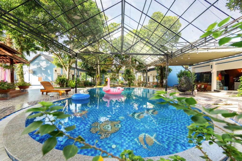 an indoor swimming pool with a glass ceiling at Trương Nhi Bungalow in Phú Quốc