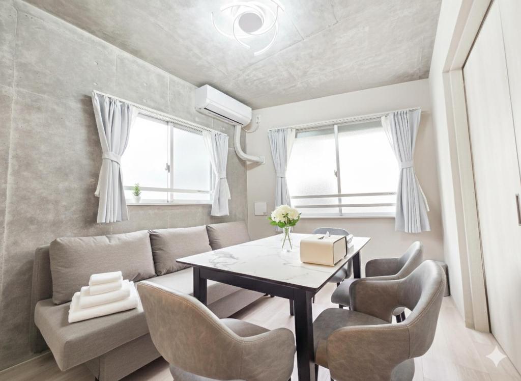 a living room with a table and chairs at NEW OPEN!! SLEEPLAB 池袋 -ikebukuro- in Tokyo