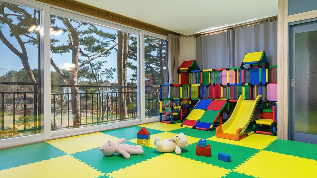 two stuffed animals laying on the floor in a play room at Goseong Pinetree Pension in Goseong