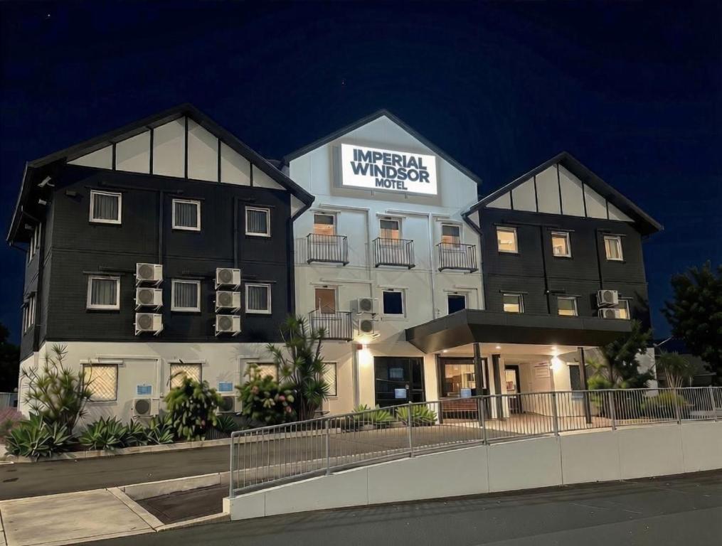 a building with a sign on the side of it at Imperial Motel Windsor in Brisbane