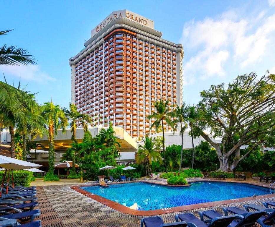 a hotel with a swimming pool in front of a building at Centara Grand at Central Plaza Ladprao Bangkok in Bangkok
