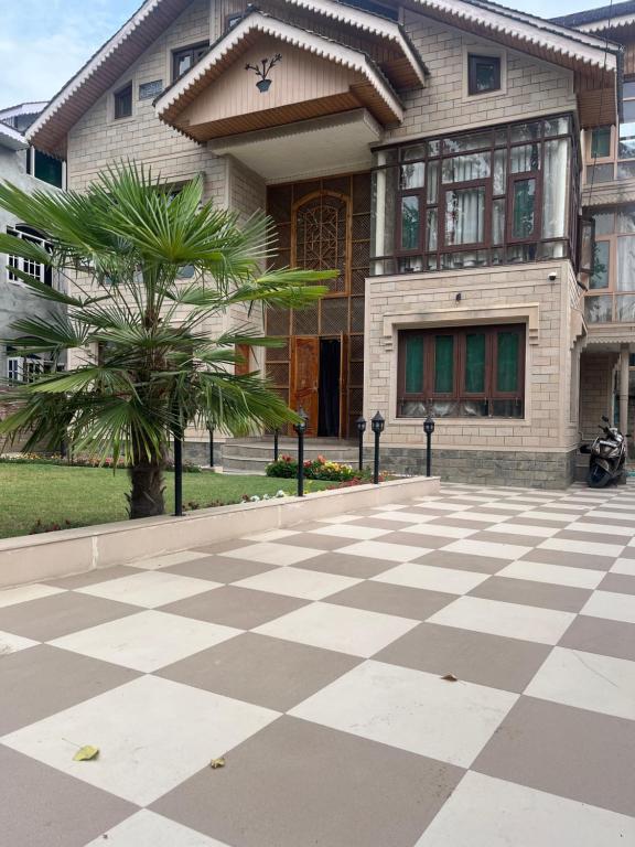 a house with a checkered floor in front of a building at p&q's guest house in Srinagar