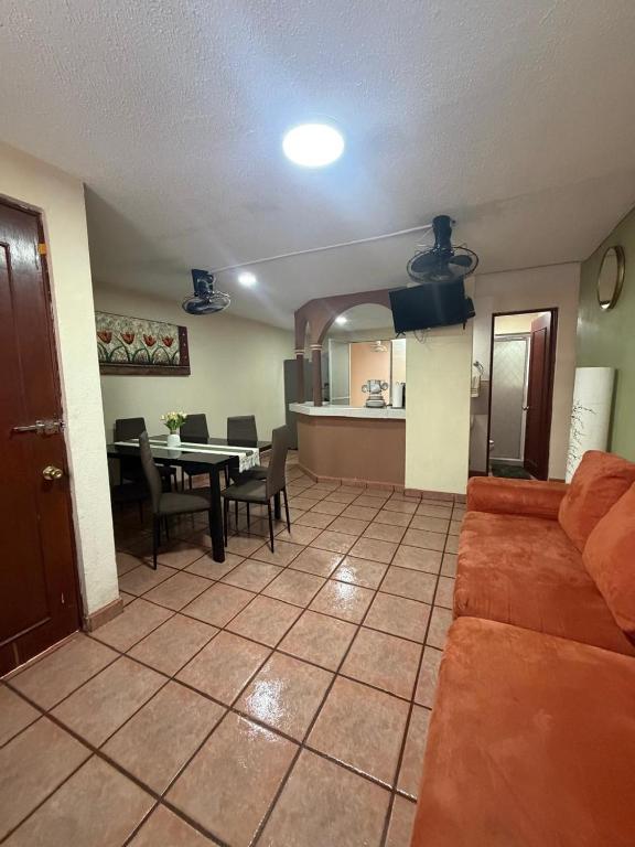 a living room with a couch and a dining room at Casa Huatulco in Santa Cruz Huatulco