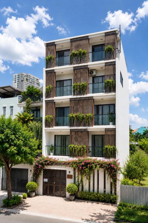 an apartment building with plants on the facade at Harbor Point Quoc Huong, Thao Dien in Ho Chi Minh City