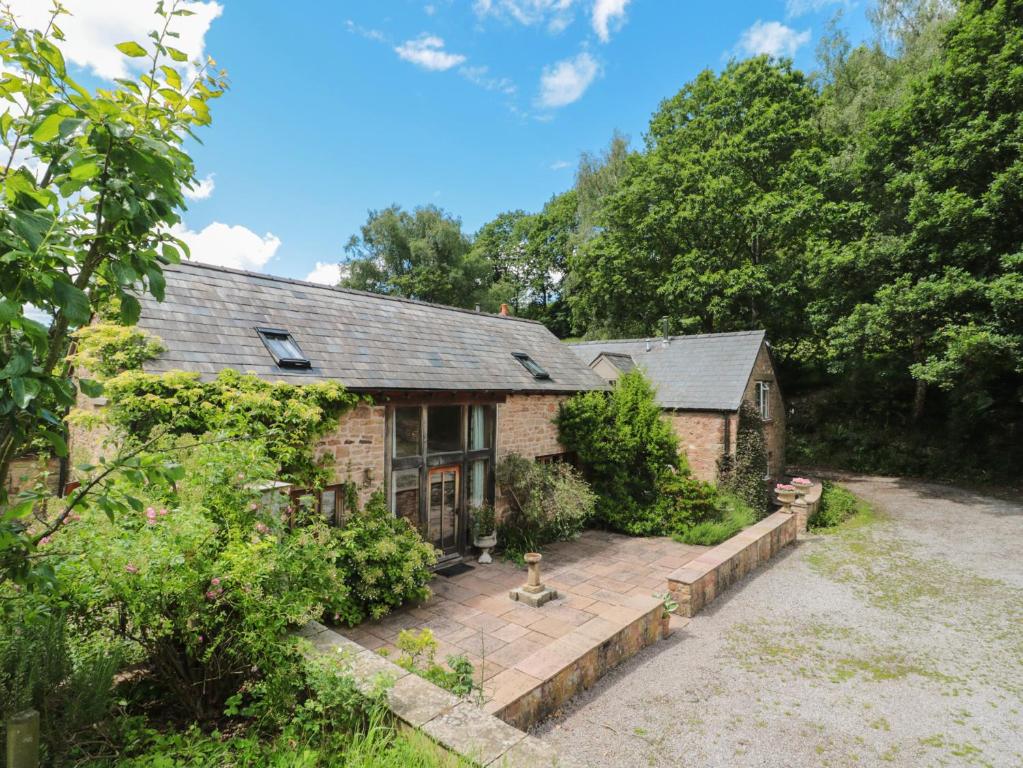 an exterior view of a house with a patio at The Lodge Farm Barn in Kerne Bridge