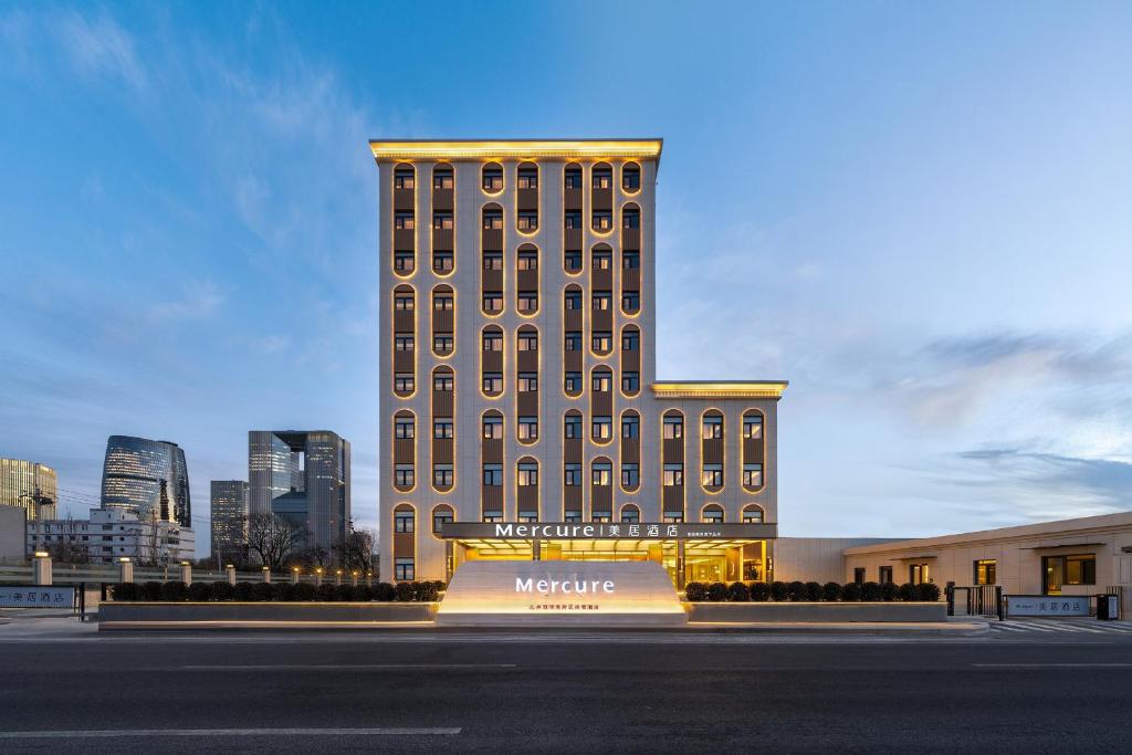 a large building with a sign in front of it at Mercure Beijing Lize Road in Beijing
