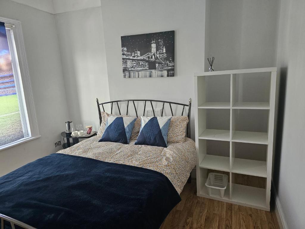 a bed with blue sheets and pillows in a bedroom at Marina Bed Liverpool City LFC in Liverpool
