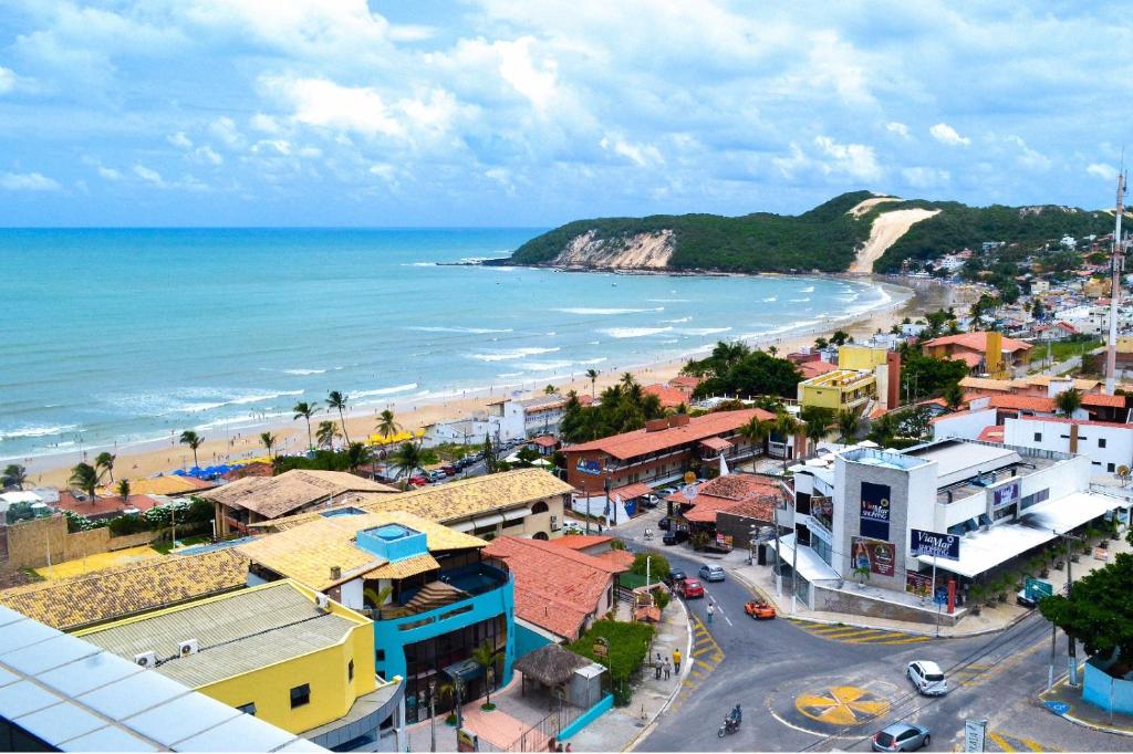 an aerial view of a town and the beach at Apartamentos Natal in Natal