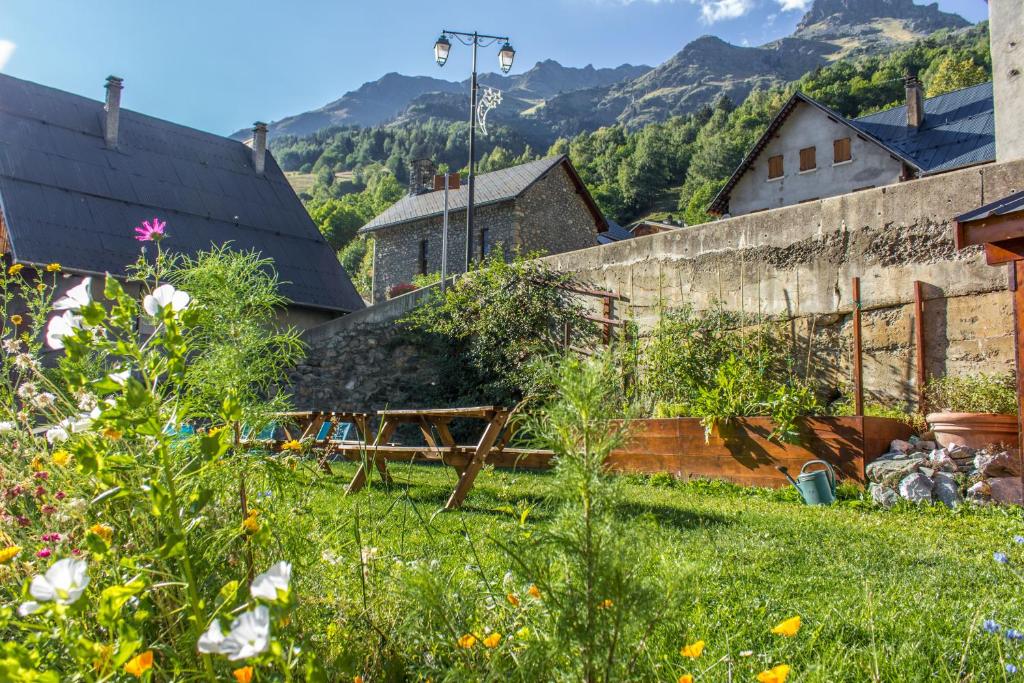 a view of a garden with mountains in the background at Chalet Dibona, cosy log fire evenings 200m from the slopes in Vaujany