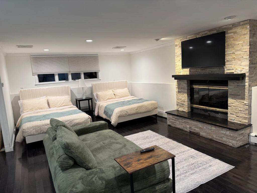 a living room with a couch and a fireplace at Studio - NYC, Greenwich, Capitol, Parking in Port Chester