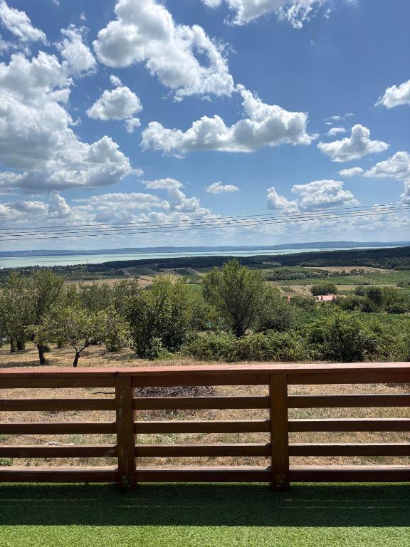 a wooden fence with a view of the horizon at Mona-Lak Balaton Panorama in Zánka