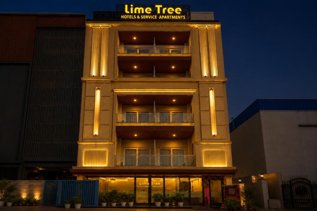 a tall building with lights on the side of it at Street Studio by Lime Tree Hotel Sector 51 Gurgaon in Gurgaon