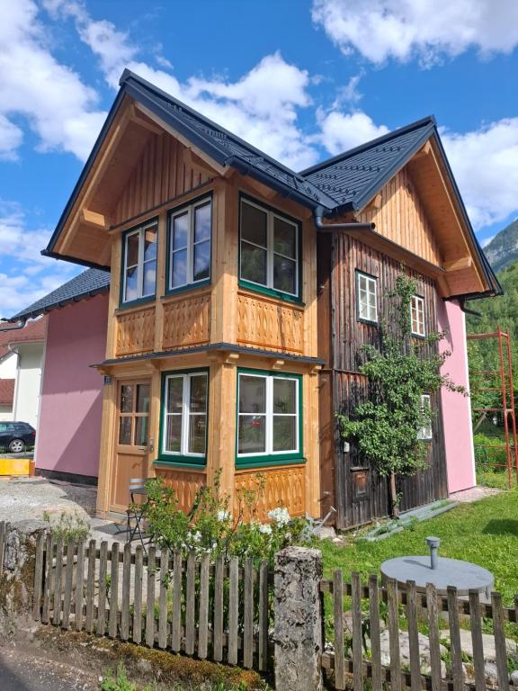 a wooden house with a fence in front of it at Haus Kern in Hallstatt