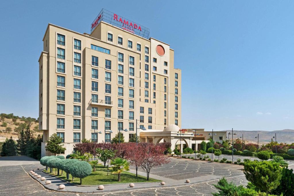 a large building with sheep statues in front of it at Ramada Plaza by Wyndham Mardin in Mardin