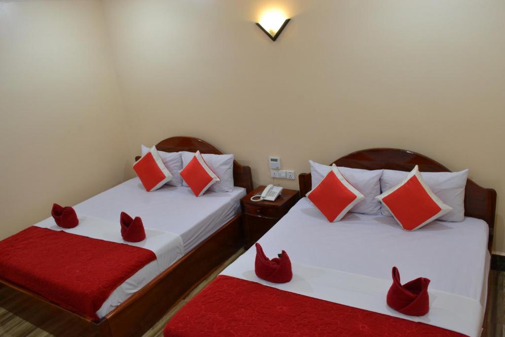 Postel nebo postele na pokoji v ubytování Capital Battambang Hotel