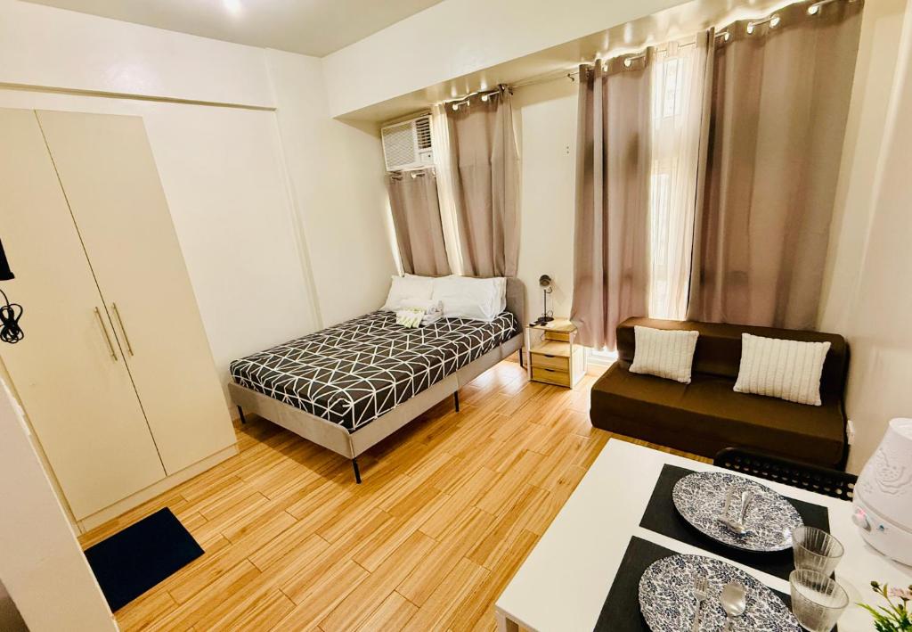a small room with a bed and a couch at JFam Suites, C4-11K Studio, Up To 4 Pax in Biñan