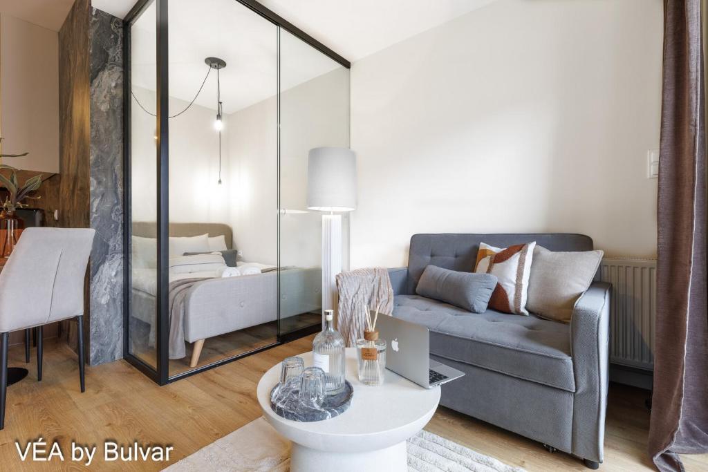 a living room with a couch and a table at VÉA by Bulvar in Kielce