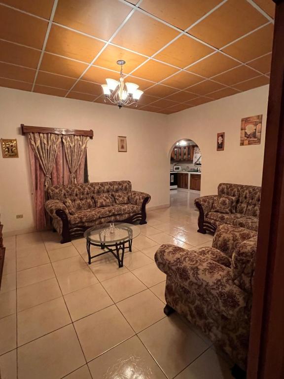 a living room with couches and a coffee table at Comfortable 3-bedroom, 1-kitchen cottage in Cerro Punta