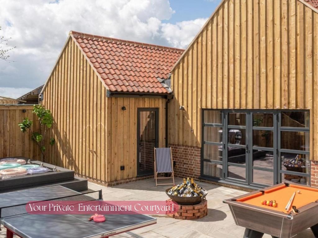 a large wooden building with a pool table at Gorgeous Stylish Home Near Longleat and Bath with Private Heated Pool and Sauna in Corsley