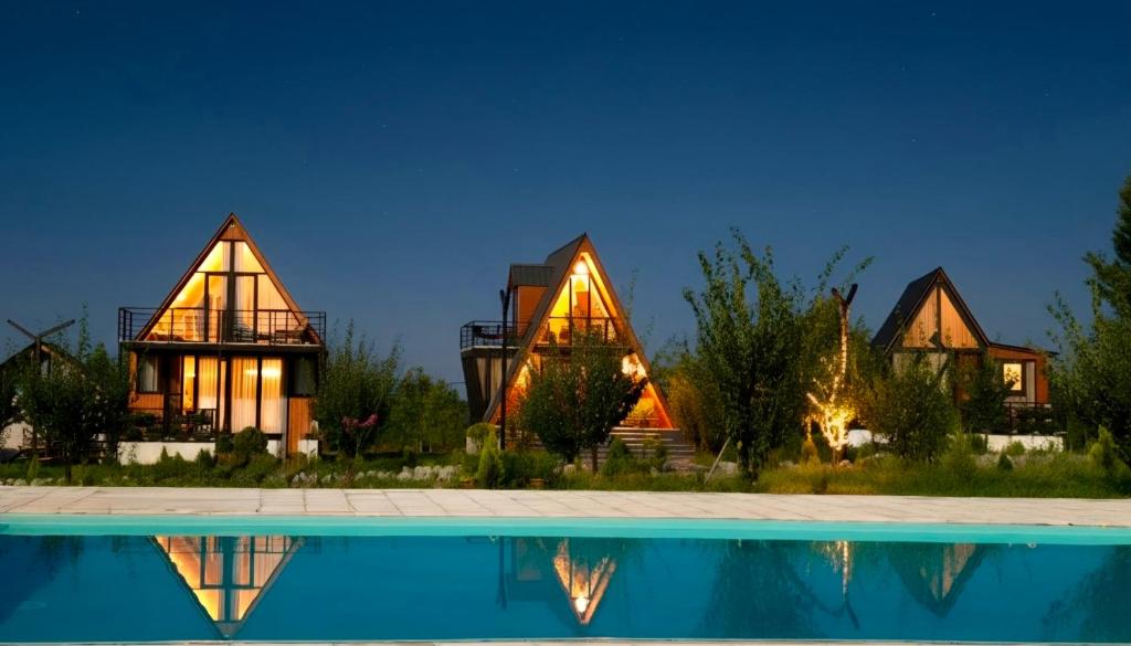 a house with a pool in front of it at Zholovani Cottages in Lagodekhi