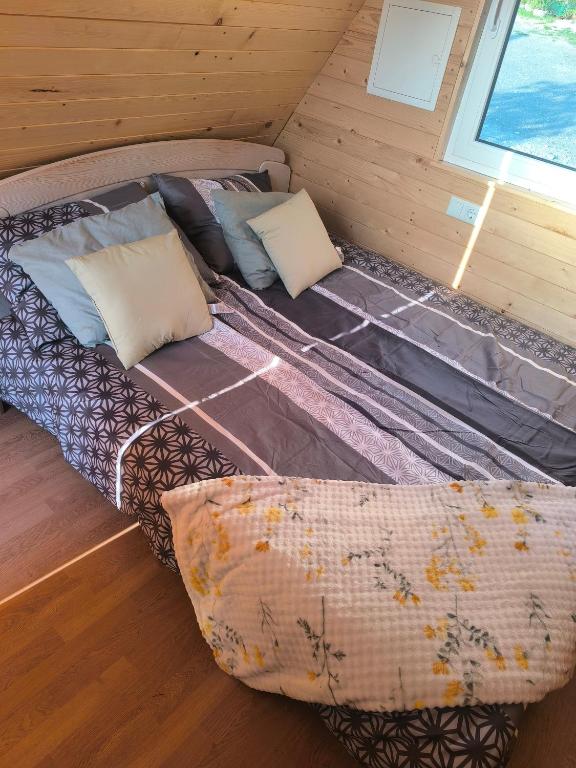 a large bed in a room with a window at Hiška Nika in Malečnik