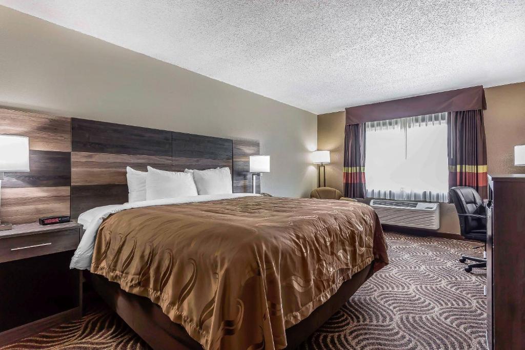 a hotel room with a bed and a window at Quality Inn & Suites Salisbury South in Salisbury