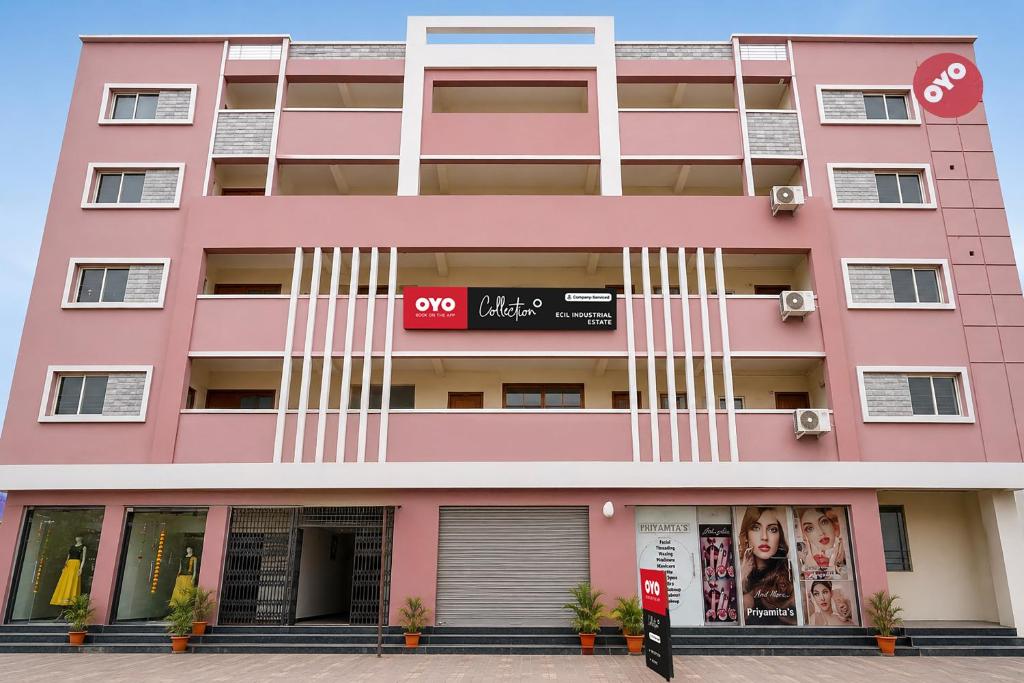 a pink building with a sign on it at Collection O ECIL Industrial Estate Formerly Hotel Cube in Maula Ali